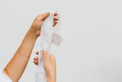 Shopper holding a grocery receipt