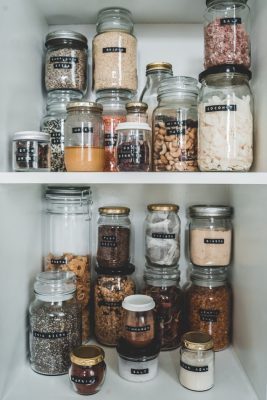 Organized pantry with staple foods in clear containers